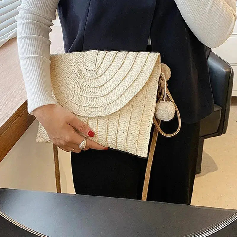 Handmade straw envelope crossbody bag in beige with a pom-pom tassel
