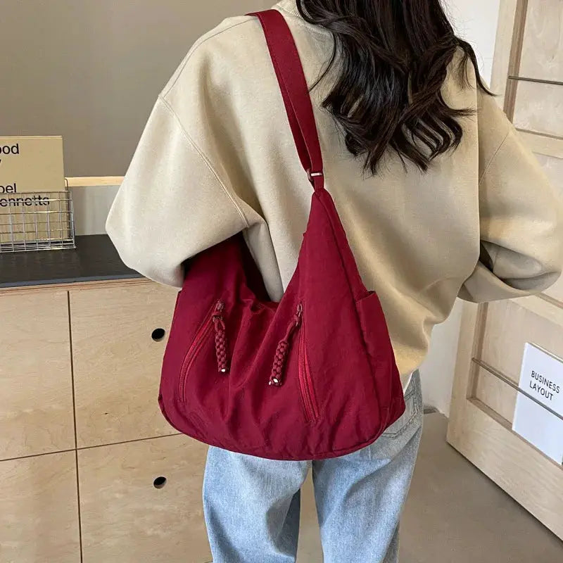 Simples Market women's soft cloth shoulder bag in solid red with two front zip pockets and braided pulls