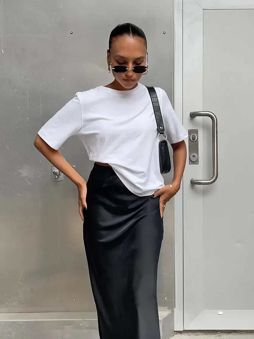 Satin black trumpet skirt, high-waist, long and office-ready.