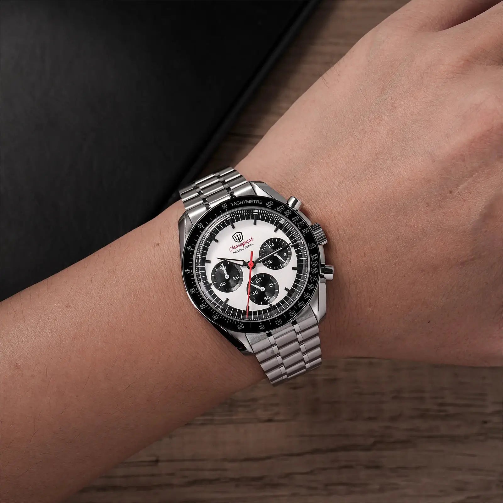 Watchdives WD1863 chronograph wristwatch on bracelet with white dial, black subdials, red seconds hand, tachymeter bezel.