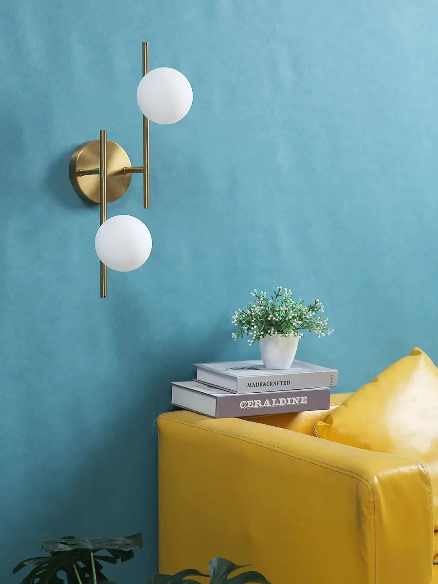 Golden modern LED wall lamp with dual milky glass globe bulbs (G9) for indoor spaces