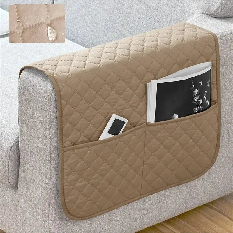 Beige quilted sofa armrest cover with pockets for remote and magazine; water-repellent fabric