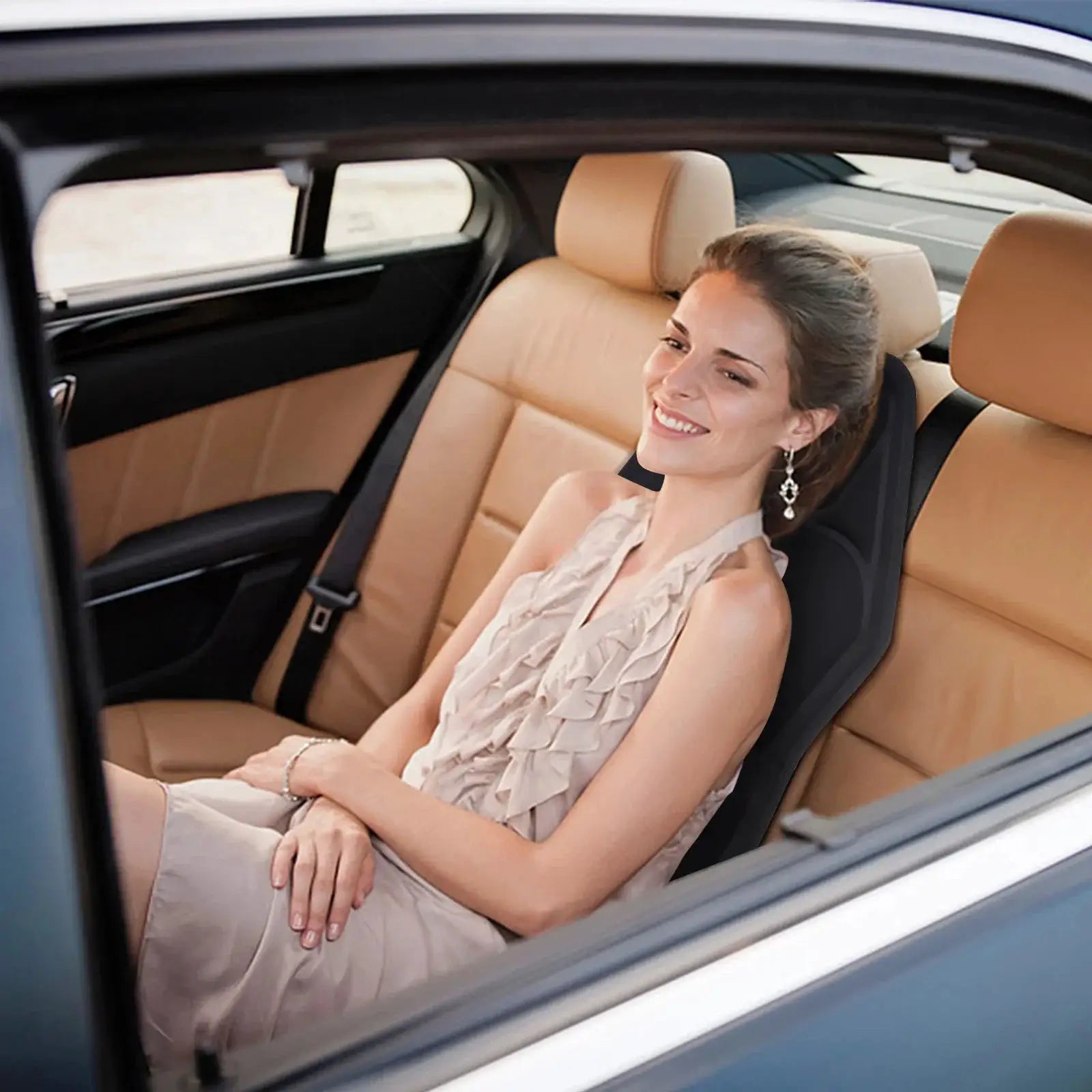 Electric back massager chair cushion in black, used in a car interior with a smiling woman seated.