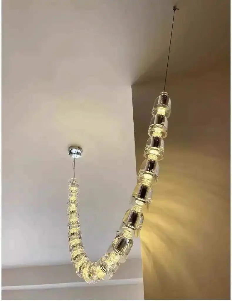 Necklace chandelier ceiling light by Simples Market with multi-strand clear crystal acrylic beads; adjustable length.