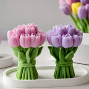 Two tulip bouquet silicone molds in pink and lavender with green stems on a white tray