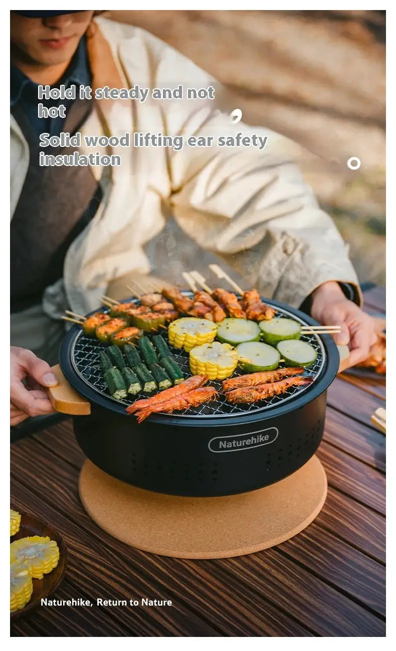 Naturehike outdoor tabletop charcoal BBQ stove, black portable grill with wooden handle.