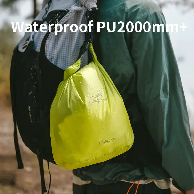Naturehike rolled storage bag; waterproof, lightweight yellow portable organizer attached to a hiking backpack.