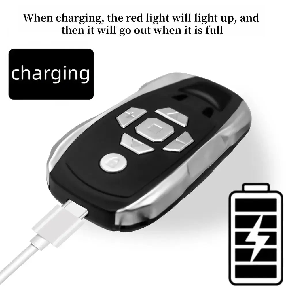 Rechargeable 20-channel key duplicator remote in black with silver trim and white buttons while charging.