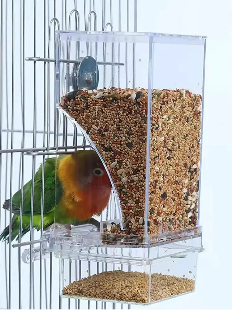 Parrot feeder by Simples Market; transparent plastic anti-spill bird food box mounted on a cage.