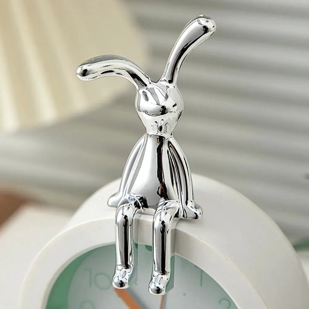 Chrome rabbit figurine for car interior center console decoration; seated atop a round clock.