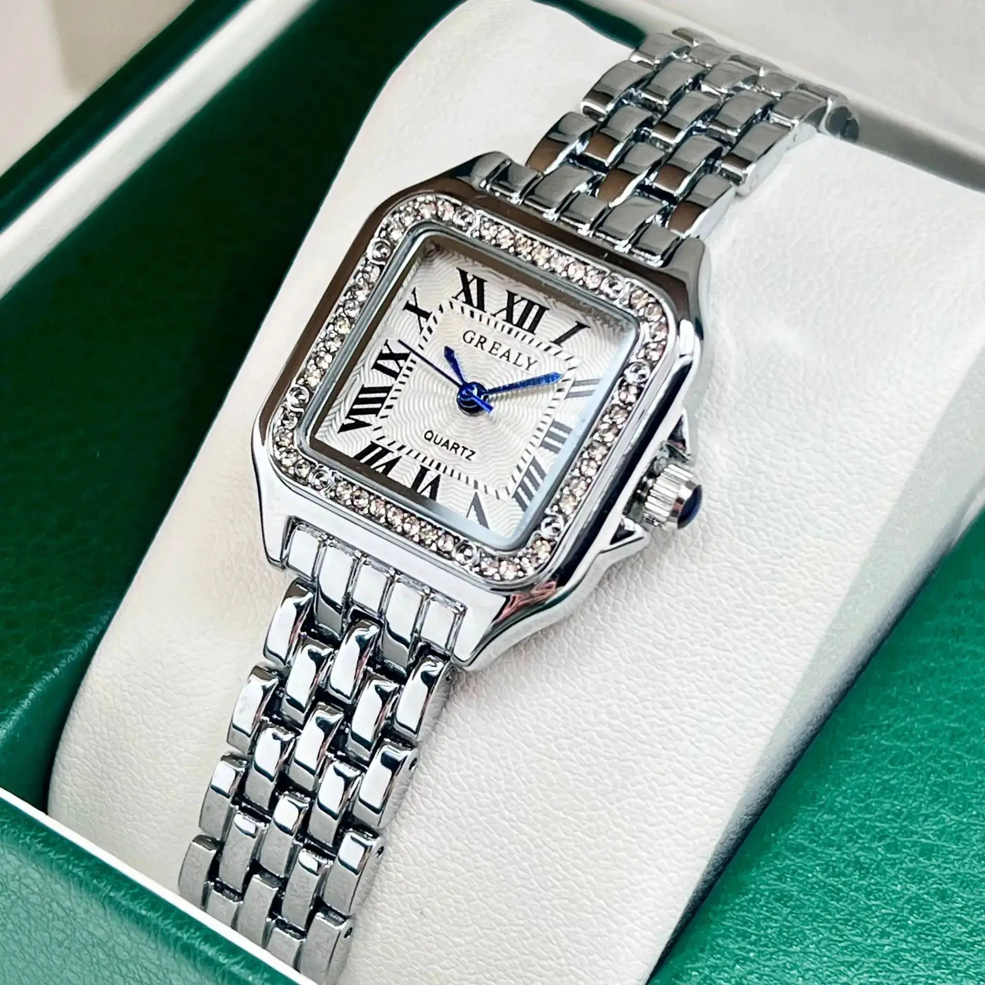 Women’s stainless steel watch with crystal bezel, square dial, Roman numerals, blue hands