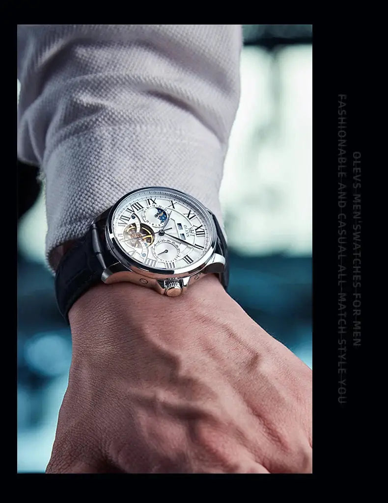 OLEVS 7013 men's watch with moon phase, Roman numerals, skeleton dial, silver case, and black leather strap
