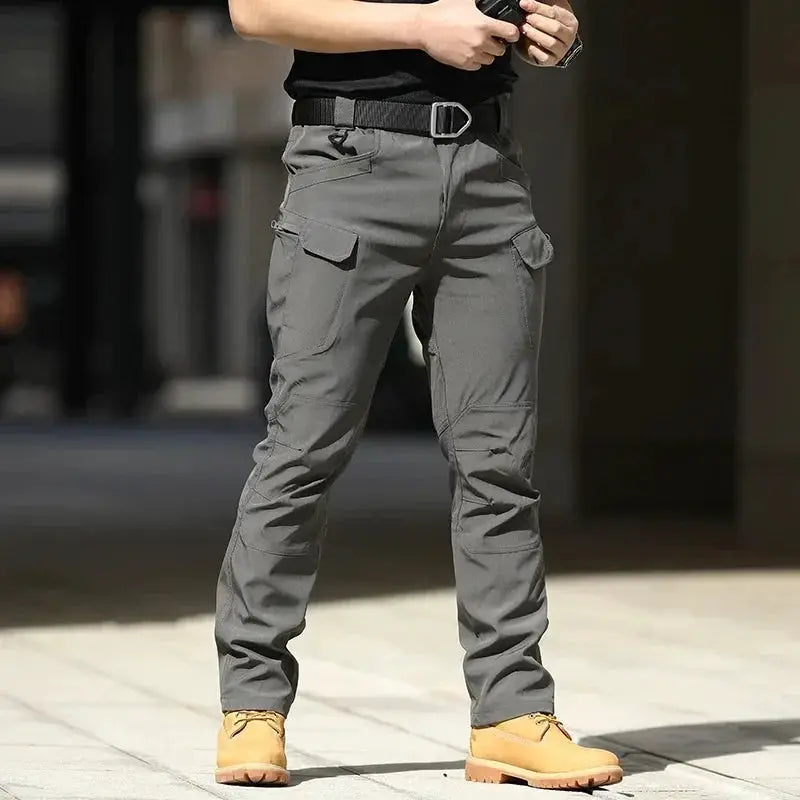 Men's grey waterproof cargo pants with belt and multiple pockets for outdoor tactical wear