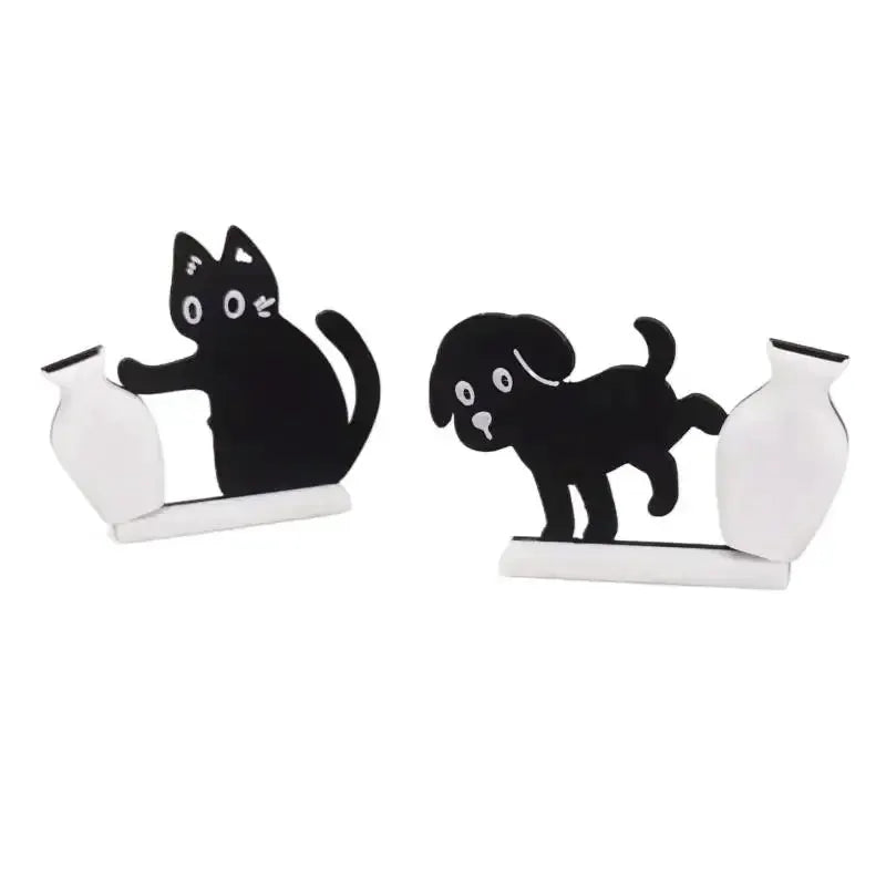Refrigerator magnets set with two black cat silhouettes pushing small white vases.