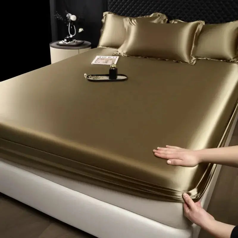 Mulberry silk 3-piece fitted sheet set with pillowcases in gold on a bed