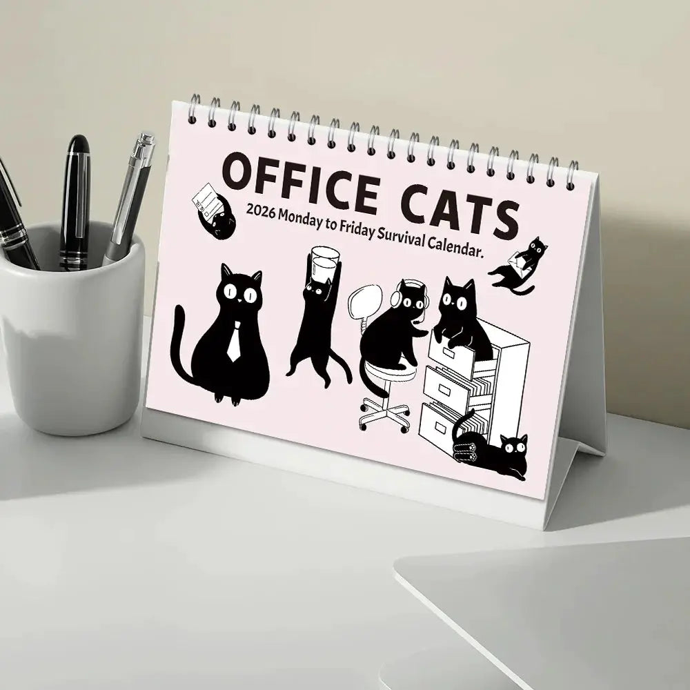 Cat-themed desktop calendar with pink cover, spiral binding, 12 months of office cats illustrations