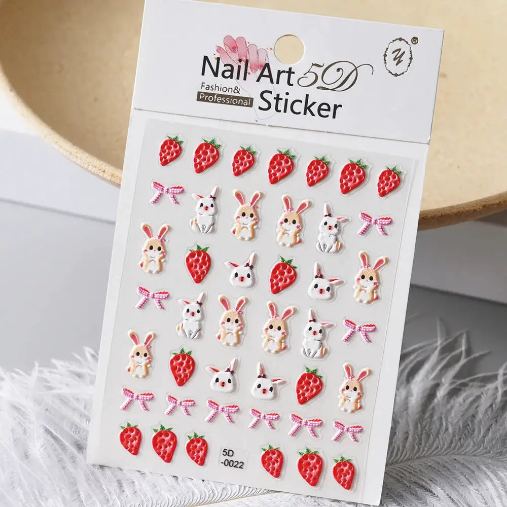 Nail art sticker sheet with 5D embossed red strawberries, bunny and bear charms and pink bows for summer manicure