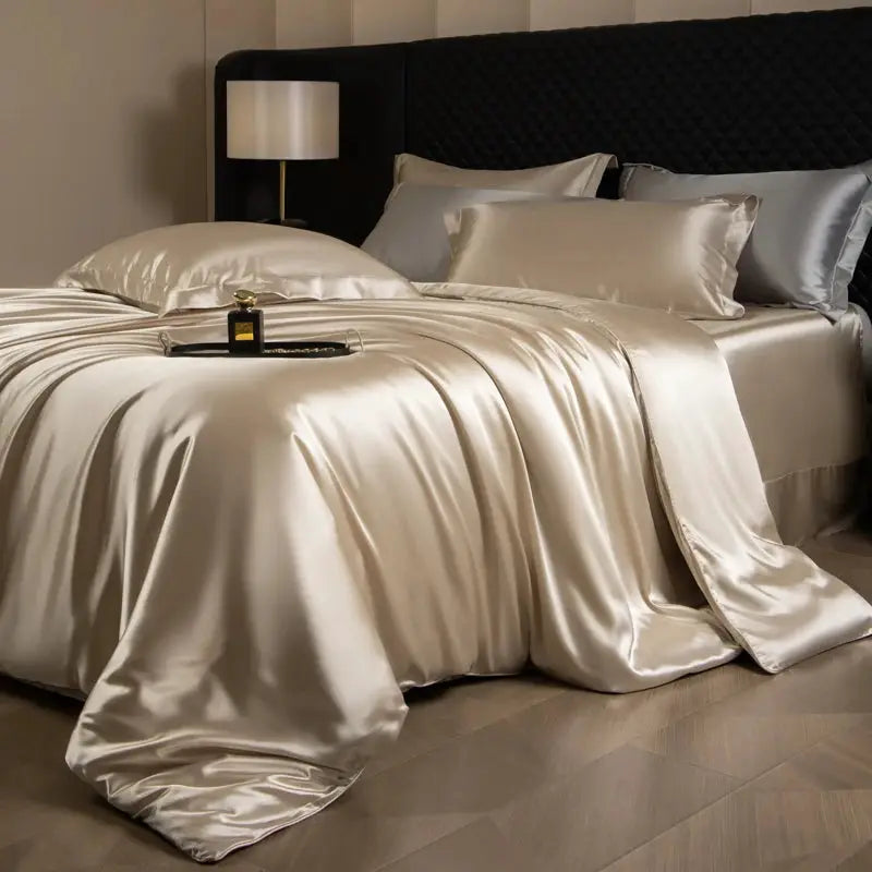 Silk bed sheet set with duvet cover and pillowcases in champagne ivory on a king bed, Simples Market