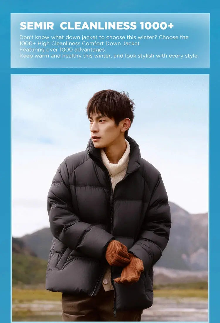 Black short puffer down jacket for men; quilted winter coat worn by man outdoors.