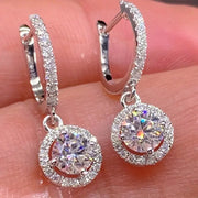 Pair of fashion round white stone earrings in silver-tone with pave hoops and crystal-encrusted circular pendants.