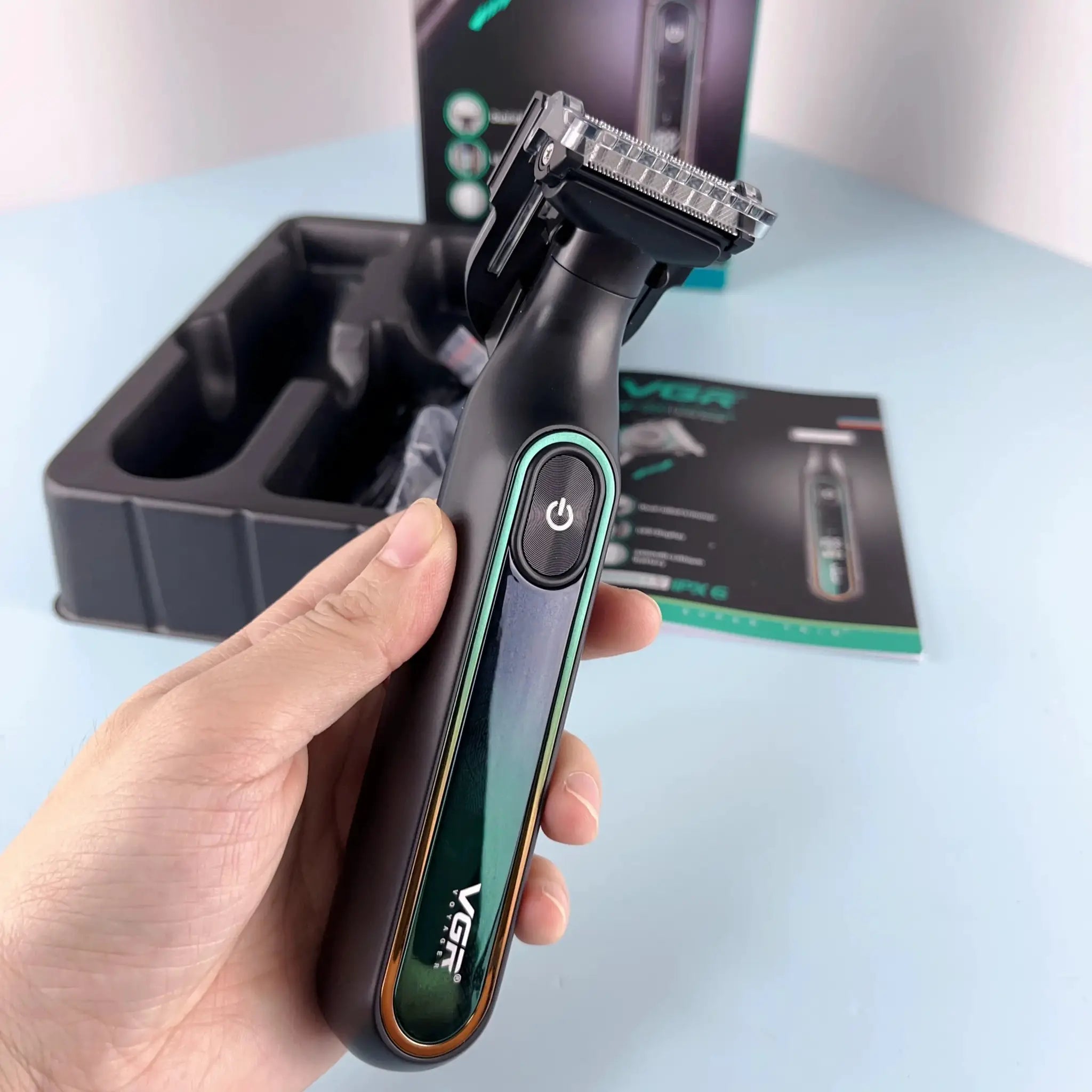 VGR 360 hair trimmer with teal accents; rechargeable, waterproof.