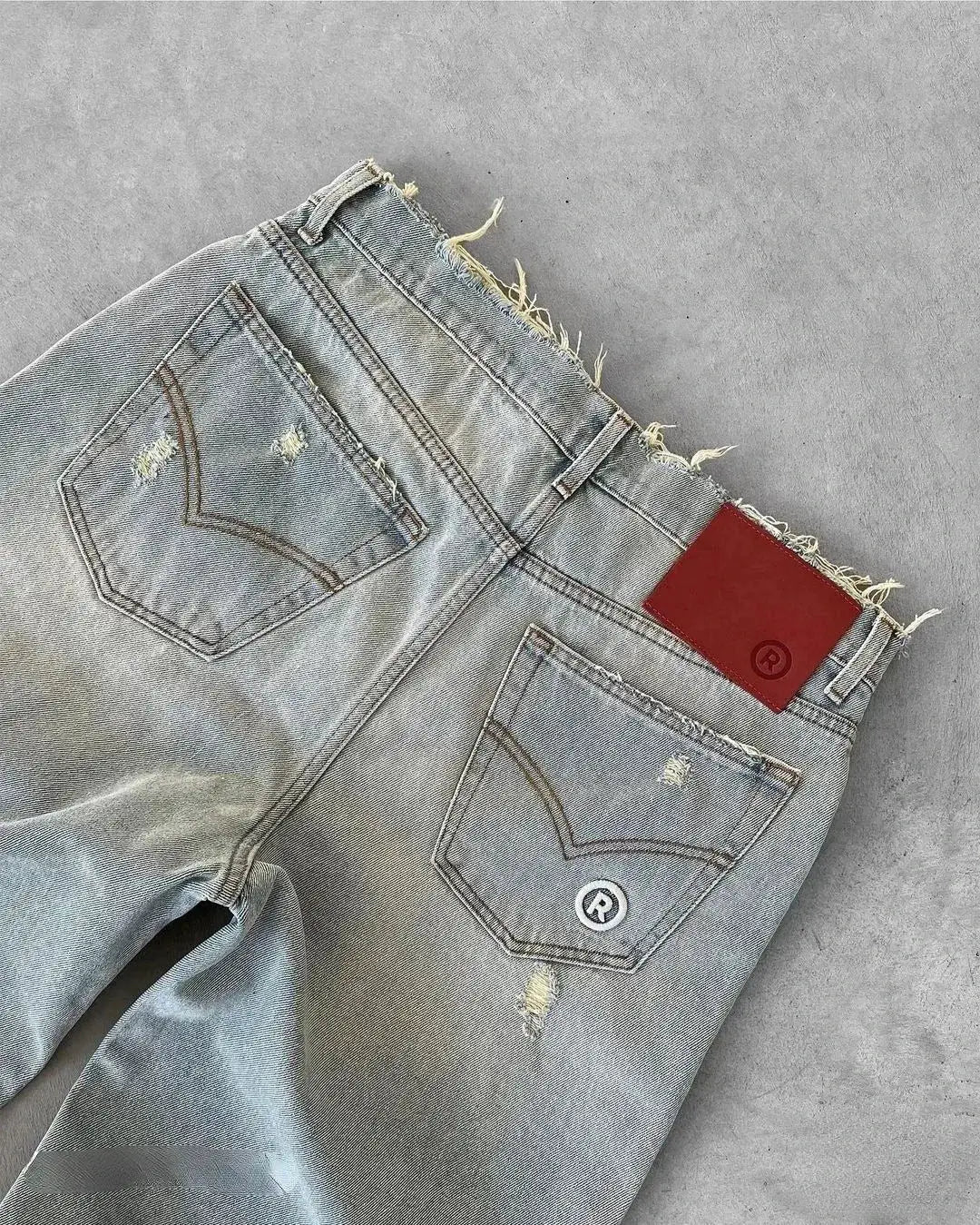 Simples Market straight distressed jeans; light-wash denim with ripped holes and back pockets.