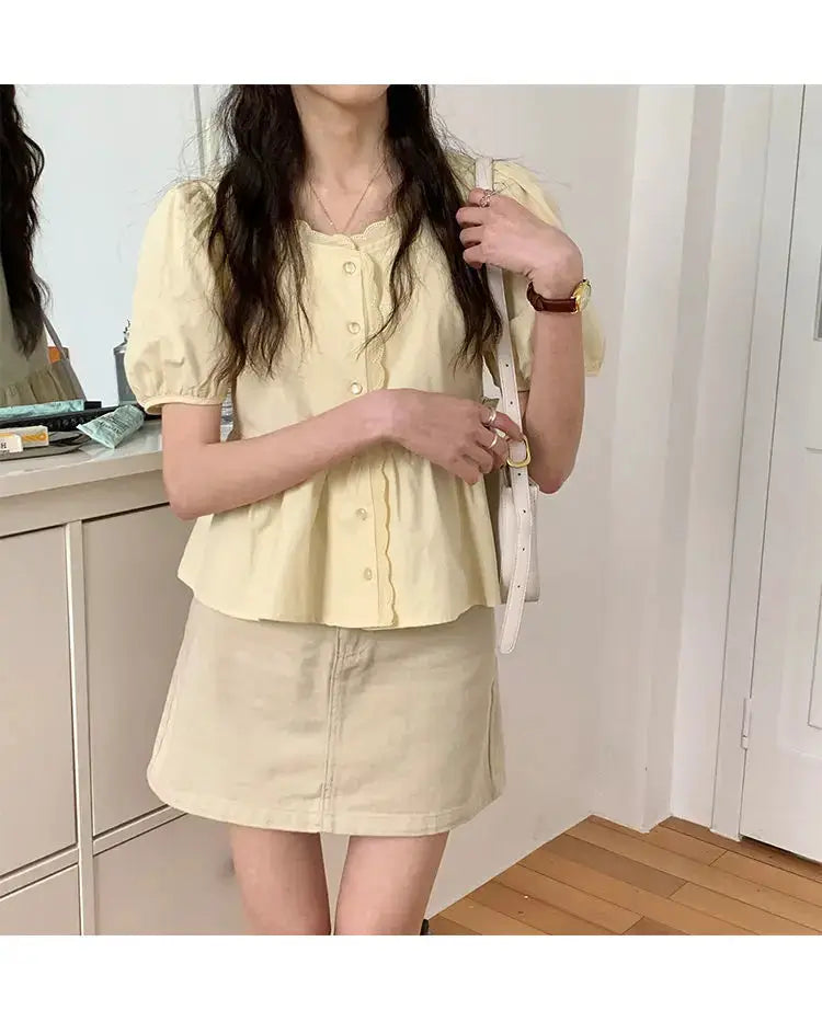 Women's pale yellow puff-sleeve blouse with button front