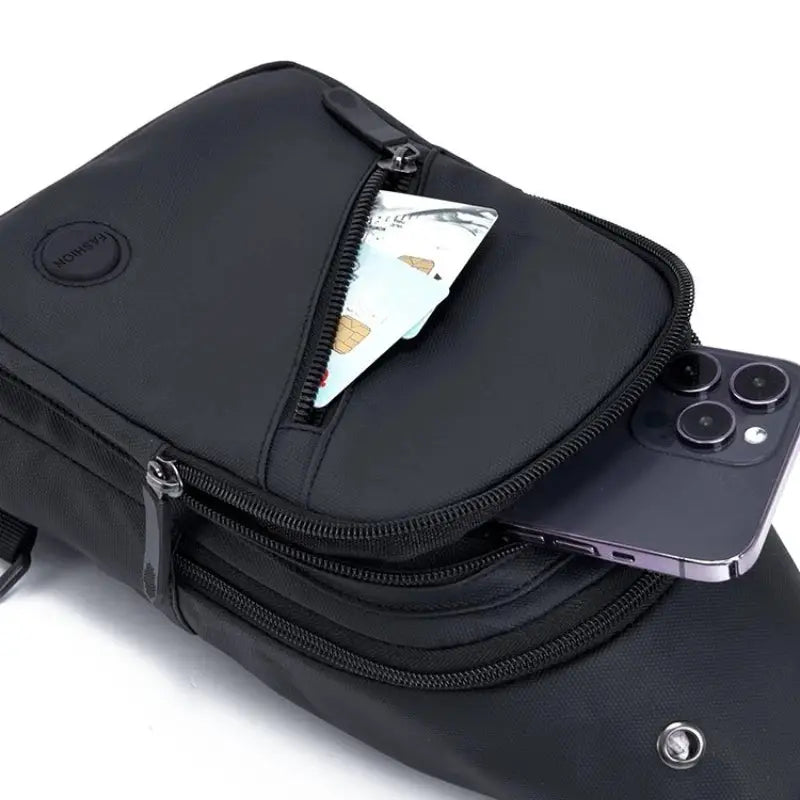 Lightweight men's chest bag in black nylon with multiple zip pockets and a phone partially visible.