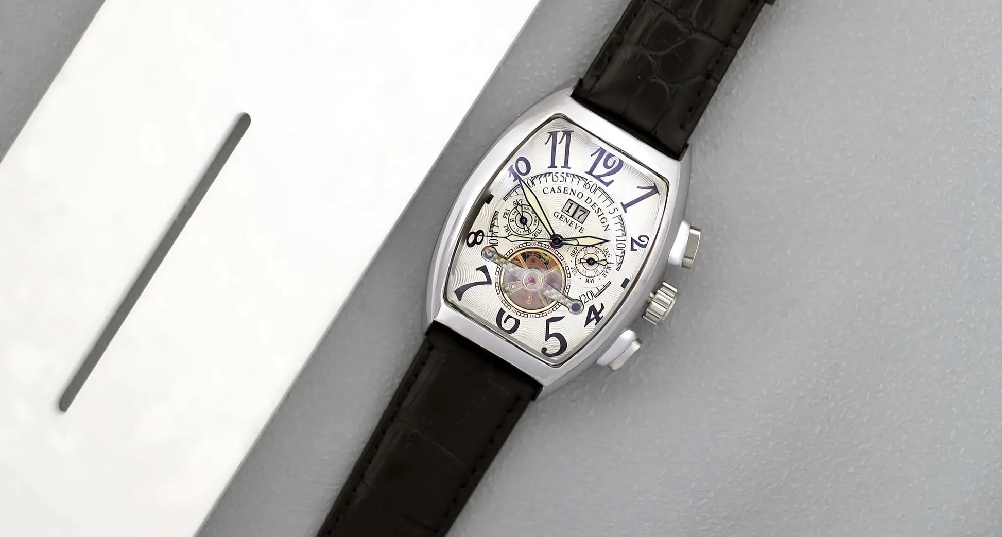 Caseno Design tourbillon skeleton watch with tonneau case, black leather strap and blue numerals