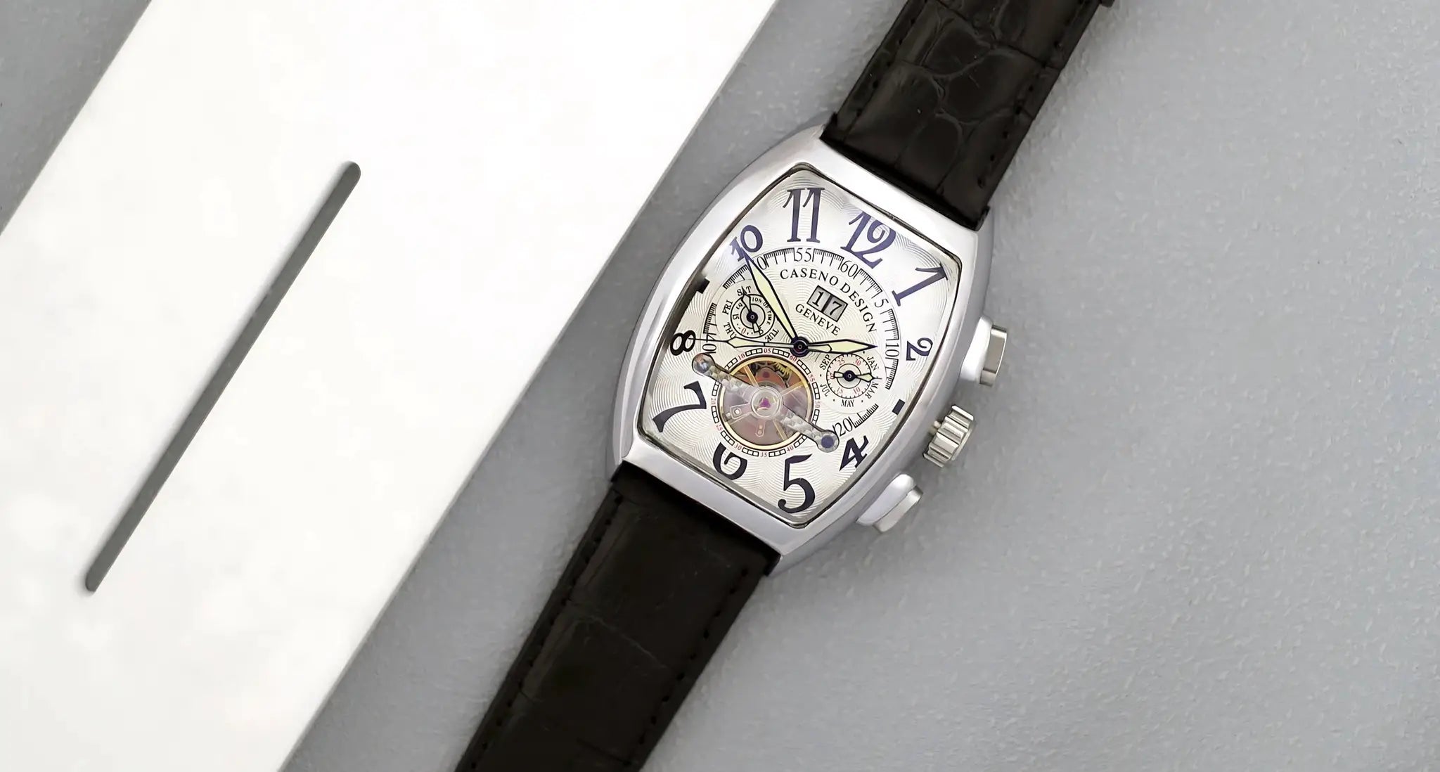 Caseno Design tourbillon skeleton watch with tonneau case, black leather strap and blue numerals