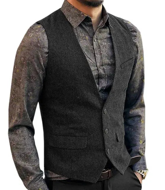 Men's herringbone waistcoat with deep V-neck, charcoal color, worn over a patterned shirt