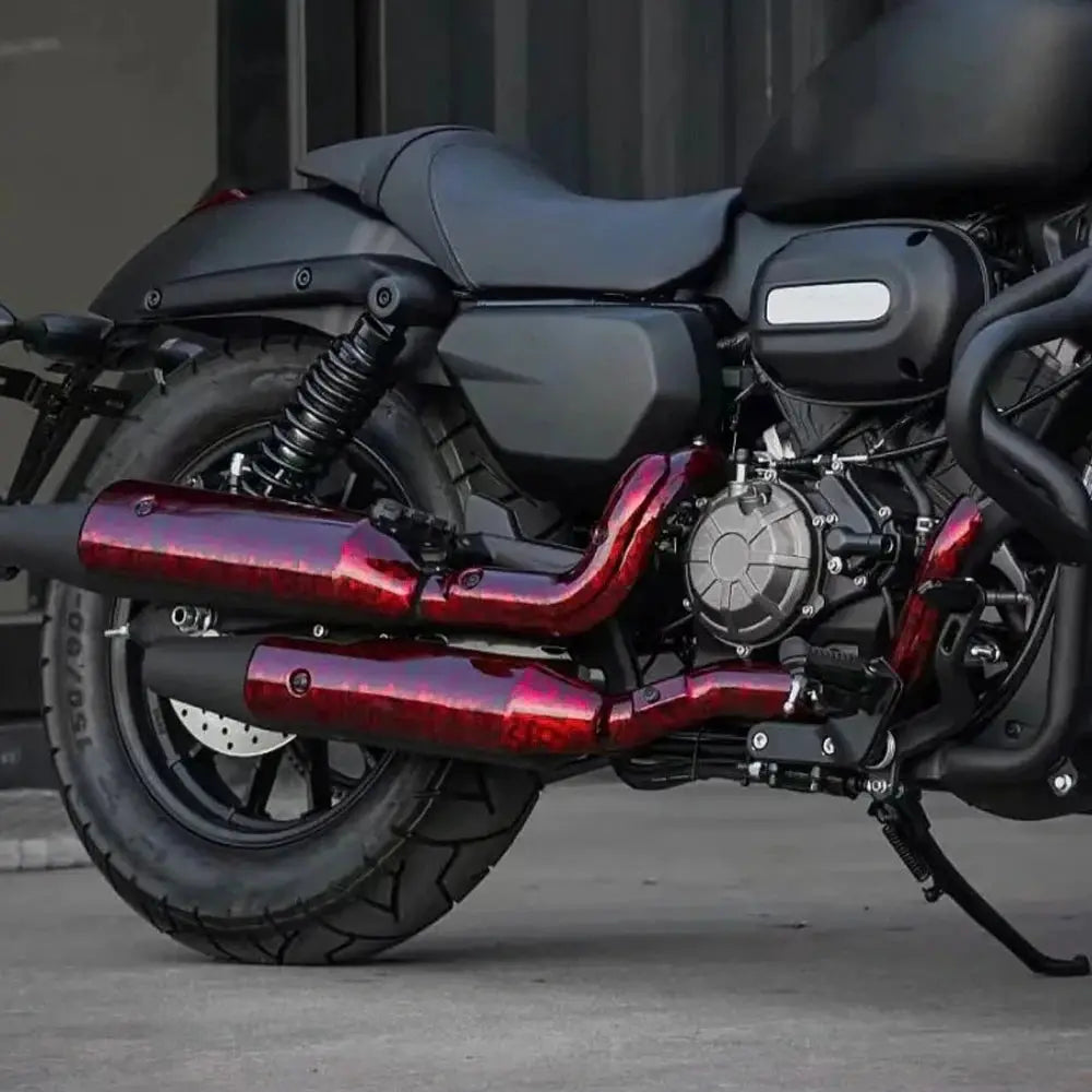 Motorcycle with glossy red exhaust pipes and black body, engine visible.