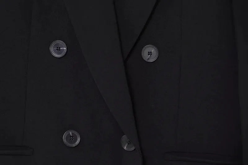 Blazer, black double-breasted with shoulder padding and visible buttons.
