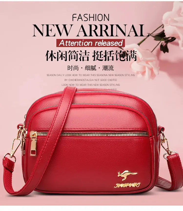 Red leather crossbody purse with gold hardware, adjustable strap and multiple pockets.