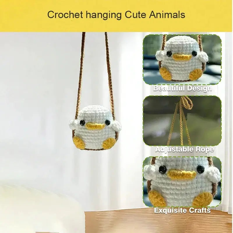 Crochet duck car pendant with white body, yellow beak and feet on a brown rope