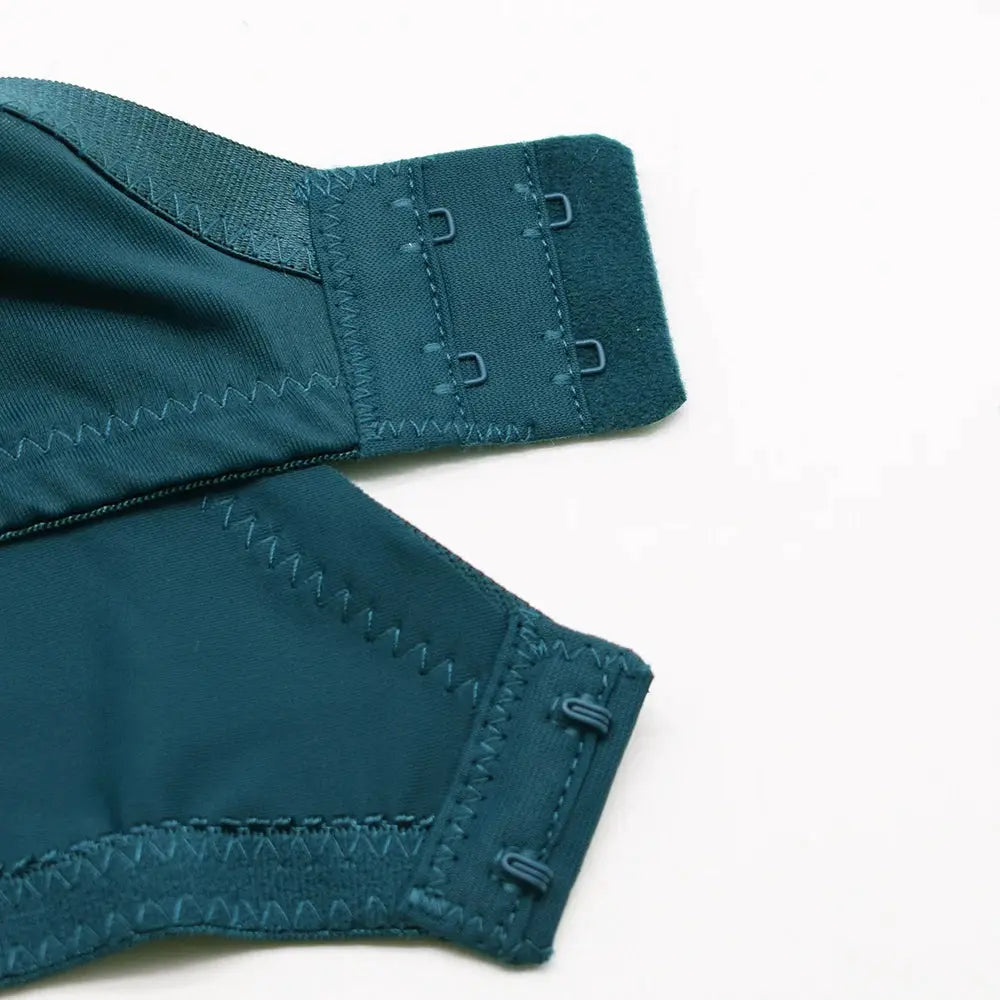 Teal plus-size bra with back hook closures and wide band, satin-like fabric.