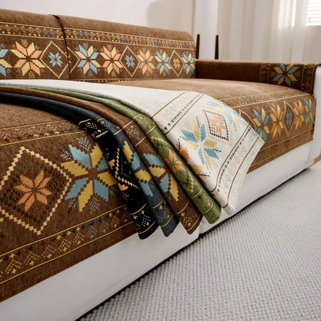 Bohemian jacquard chenille sofa cover by Simples Market on a brown patterned sofa with folded multi-color throws