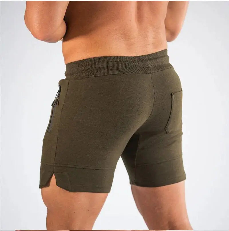 Men's olive green jogger shorts with zippered pocket, elastic waistband, mid-thigh length.