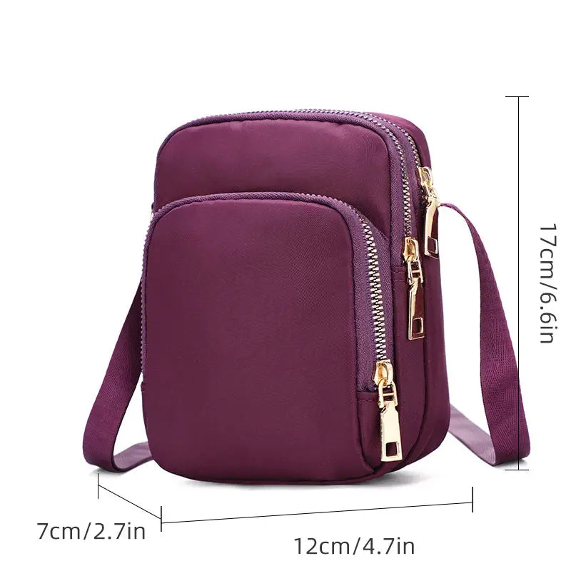 Purple waterproof crossbody bag with two zippered pockets.