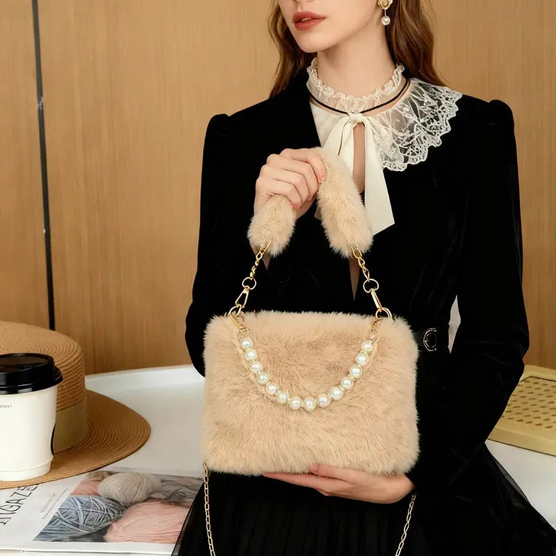 Simples Market pearl rabbit fur handbag; beige rabbit fur crossbody bag with pearl handle and gold chain.
