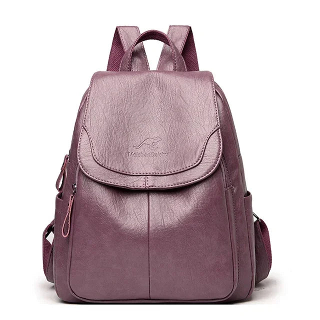 Soft leather backpack for women by Simples Market in mauve purple with front flap and top handle