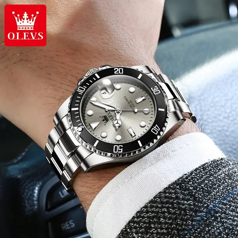 OLEVS 5885 stainless steel diving watch on wrist with black bezel, silver dial and luminous markers