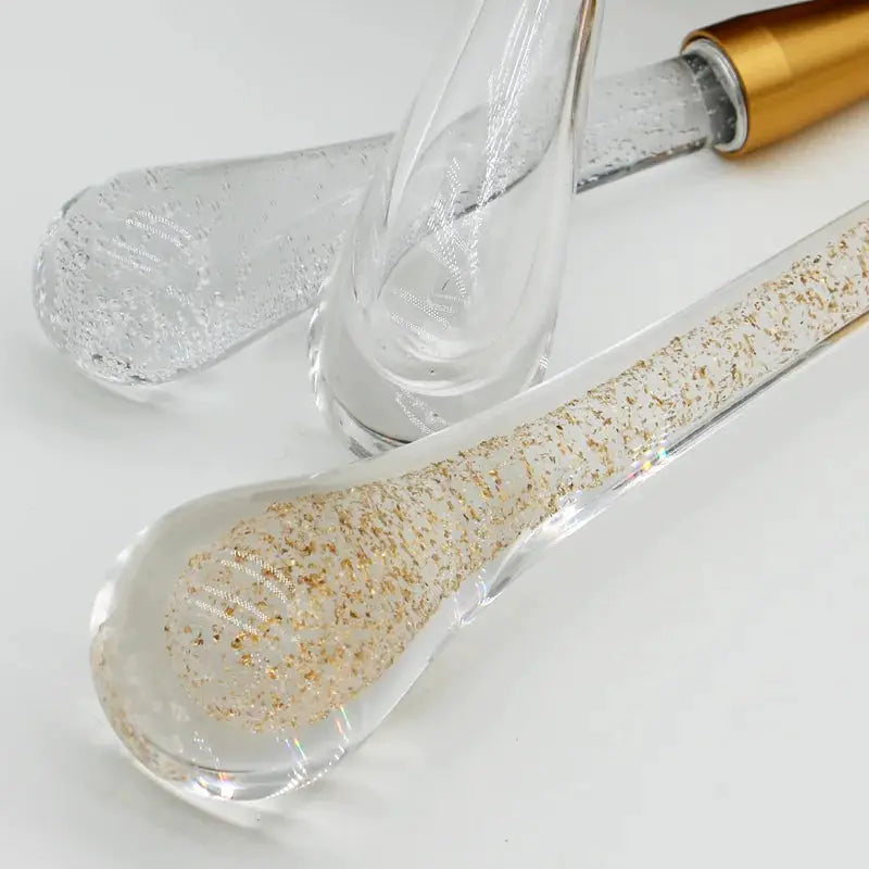 Crystal LED pendant lights by Simples Market; set of three clear glass drops with gold glitter inside.