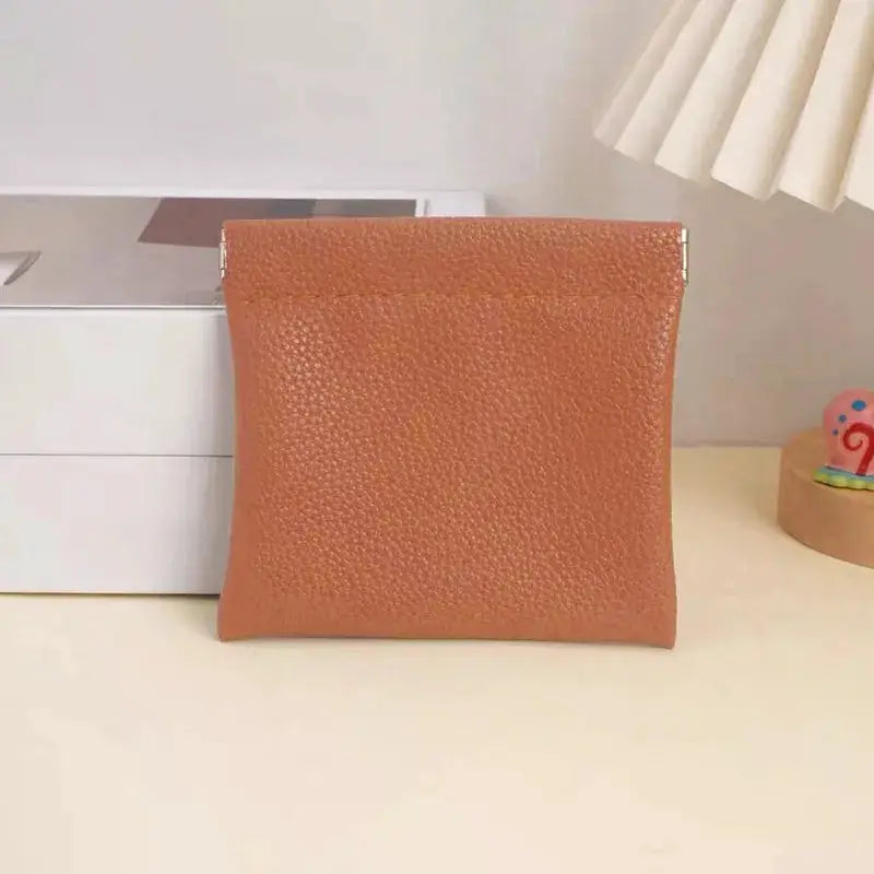 Self-closing artificial leather long wallet in tan brown with a textured faux leather finish