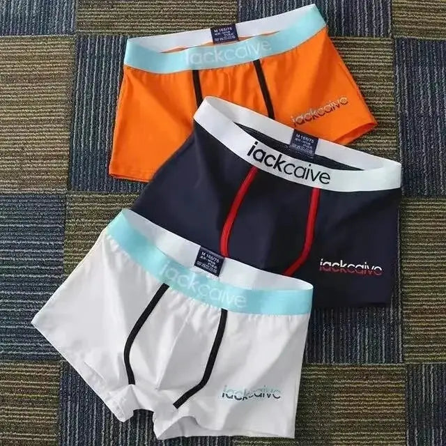 3-pack men's cotton boxer briefs by Simples Market in white, navy, and orange with light blue waistbands.
