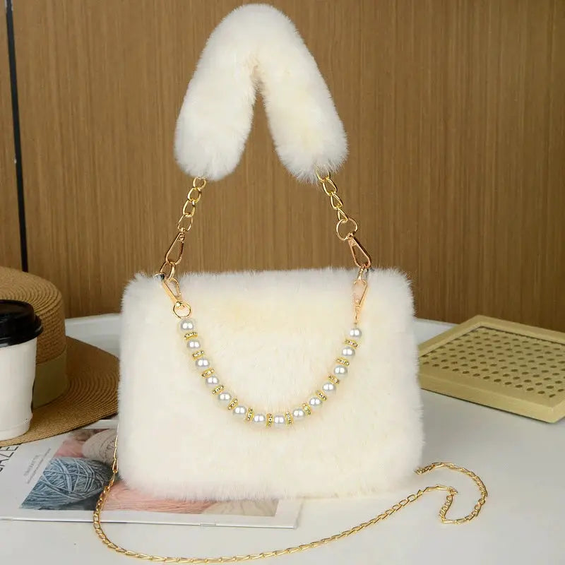 Fashionable pearl rabbit fur handbag by Simples Market, ivory crossbody with pearl bead chain and fluffy top-handle.
