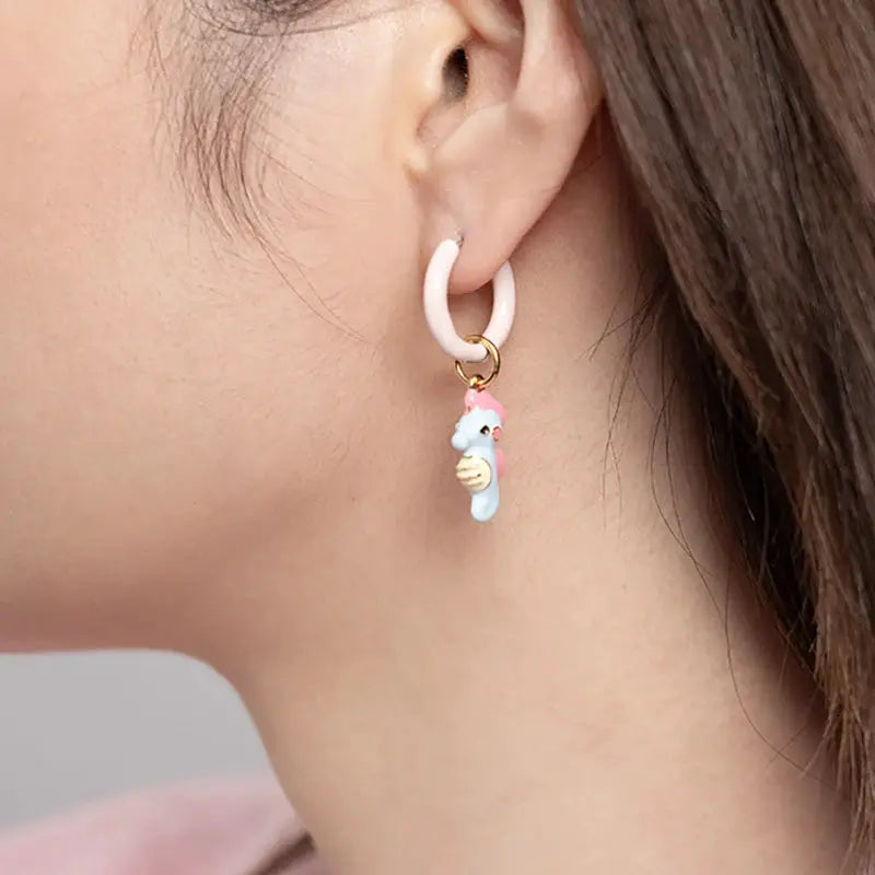 Single hoop earring with pastel blue dinosaur charm on white hoop