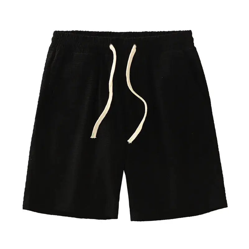 Men's black shorts with white drawstring, knee-length, elastic waist, waffle-textured fabric