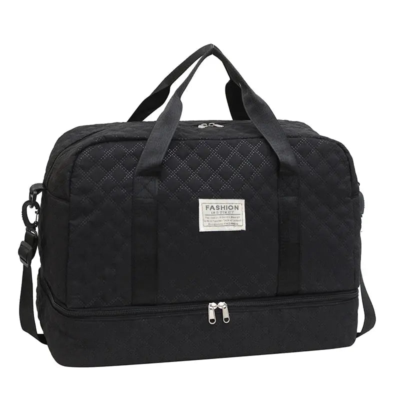 Black quilted duffle bag with top handles and detachable shoulder strap, front fashion emblem, spacious zip compartments