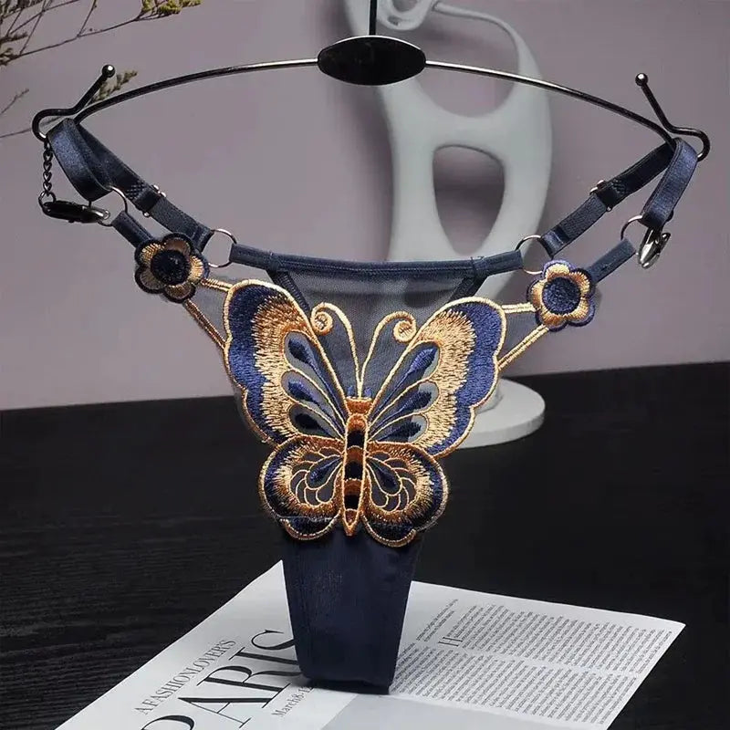 Butterfly lace thong for women, navy blue low-waist G-string with embroidered butterfly motif and adjustable straps.